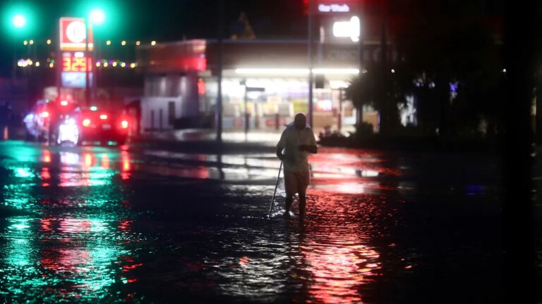 Man walks in floodwaters in South Carolina after Idalia.jpg