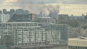 Inferno Strikes Bow Road: Sky Enveloped in Smoke as Massive Blaze Engulfs High Street”