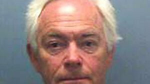 Alcoholic headteacher who sexually assaulted two young female pupils with special needs is caged