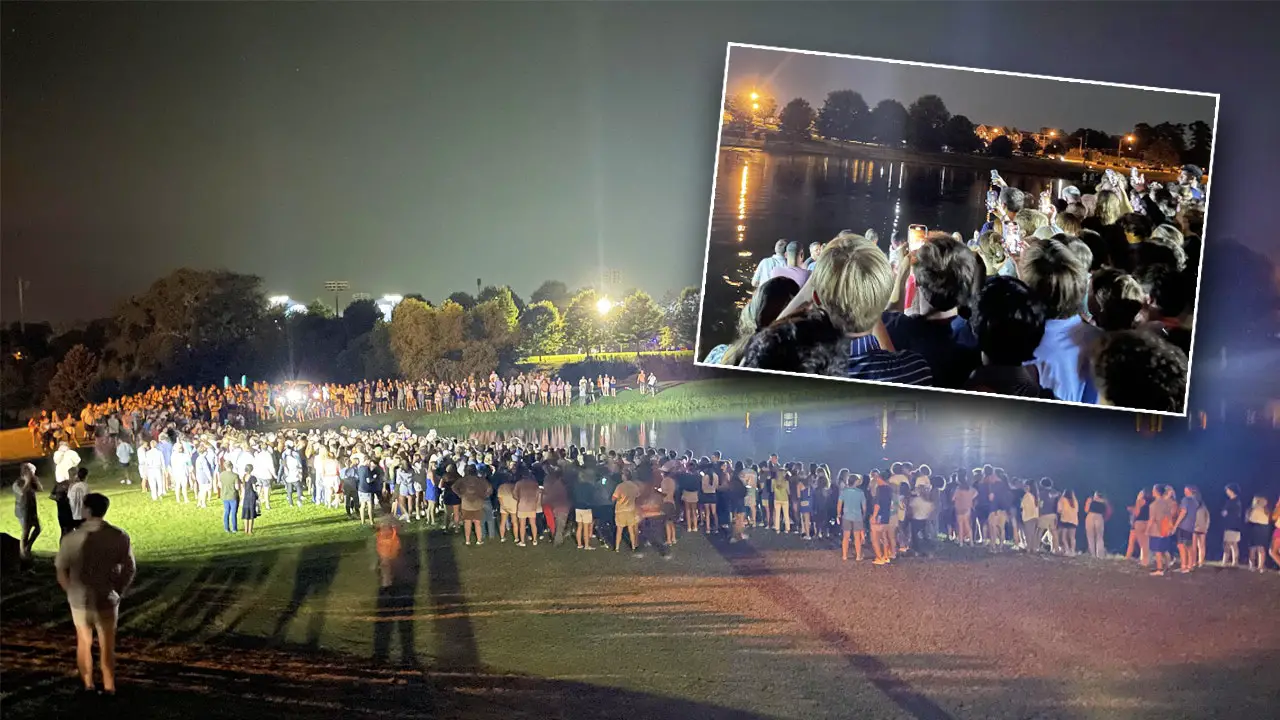 Auburn students rush into lake for impromptu baptisms as football coach lends a hand at massive worship event