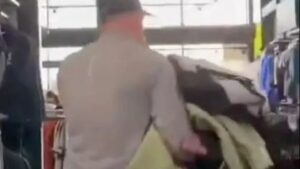 Shocking moment looters raid JD Sports store grabbing handful of clothes as shop assistant tries to stop them