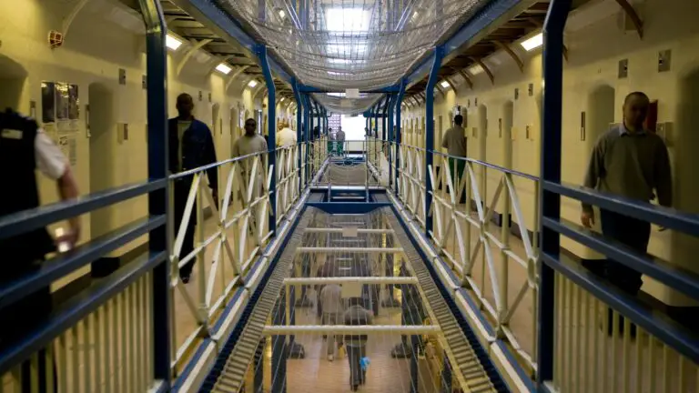 prison officers prisoners walk corridor 556638278.jpg