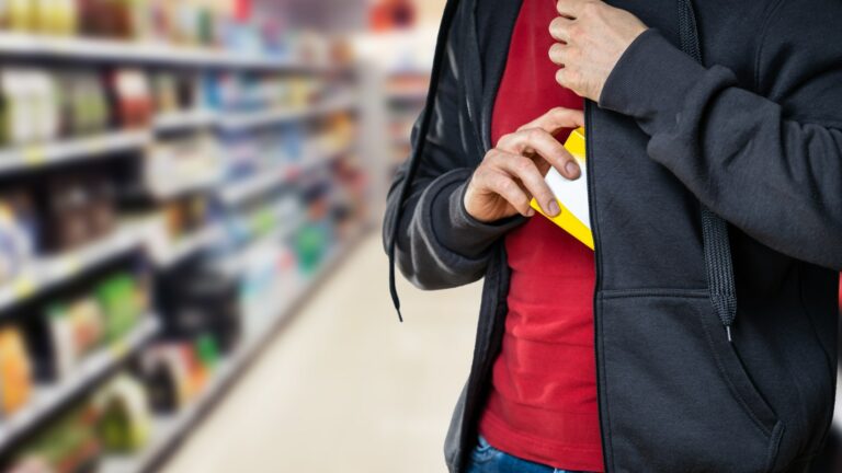 retail shoplifting man stealing supermarket 842169859.jpg